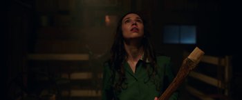 Movie still from “Annabelle: Creation” (2017), directed by David F. Sandberg – A woman in a green shirt looking up at the ceiling; Medium shot, Low angle