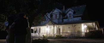 Movie still from “Annabelle: Creation” (2017), directed by David F. Sandberg – A house that has a tree in front of it at night time; Extreme Wide shot, Low angle