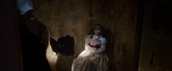 Movie still from “Annabelle: Creation” (2017), directed by David F. Sandberg – A creepy doll sitting in a chair next to a wall; Medium shot, High angle
