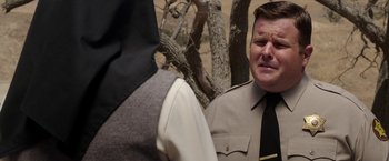 Movie still from “Annabelle: Creation” (2017), directed by David F. Sandberg – A man in a suit and tie standing in front of a tree; Close Up shot, Over the shoulder angle