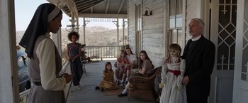 Movie still from “Annabelle: Creation” (2017), directed by David F. Sandberg – A group of people sitting on a porch; Wide shot, High angle