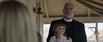 Movie still from “Annabelle: Creation” (2017), directed by David F. Sandberg – An old man and a doll in a room; Close Up shot, Over the shoulder angle