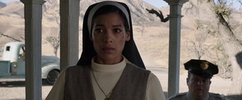 Movie still from “Annabelle: Creation” (2017), directed by David F. Sandberg – A woman wearing a nun's outfit and a cross necklace; Close Up shot, Low angle