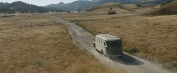 Movie still from “Annabelle: Creation” (2017), directed by David F. Sandberg – A van driving down a dirt road in the middle of a field; Extreme Wide shot, High angle