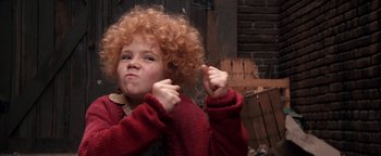 Movie still from “Annie” (1982), directed by John Huston – A young child with red hair and a red sweater; Close Up shot, High angle