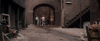 Movie still from “Annie” (1982), directed by John Huston – A group of people walking down a street; Wide shot, High angle