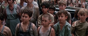 Movie still from “Annie” (1982), directed by John Huston – A group of young men standing next to each other; Medium shot, High angle