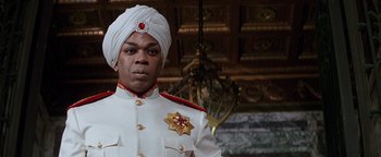 Movie still from “Annie” (1982), directed by John Huston – A man wearing a white uniform and a turban; Close Up shot, Low angle