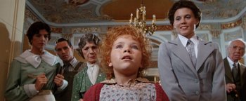 Movie still from “Annie” (1982), directed by John Huston – A young girl with red curly hair looking up at the ceiling; Close Up shot, Low angle