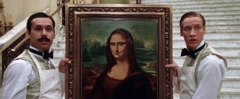 Movie still from “Annie” (1982), directed by John Huston – A painting of mona lisa is displayed in an ornate frame; Extreme Close Up shot, High angle