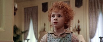 Movie still from “Annie” (1982), directed by John Huston – A young girl with red hair looking up at the sky; Close Up shot, High angle