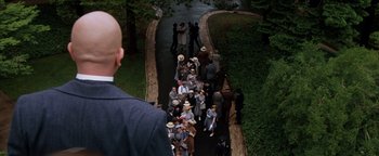 Movie still from “Annie” (1982), directed by John Huston – A group of people walking down a path; Wide shot, High angle