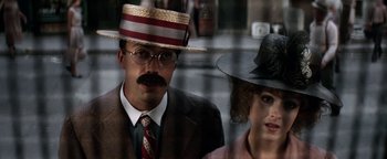 Movie still from “Annie” (1982), directed by John Huston – A man and a woman wearing hats and glasses; Close Up shot, Low angle