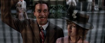 Movie still from “Annie” (1982), directed by John Huston – A man and a woman standing next to each other; Close Up shot, Low angle