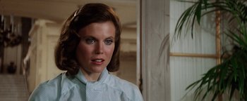 Movie still from “Annie” (1982), directed by John Huston – A person wearing a dress shirt; Close Up shot, Over the shoulder angle