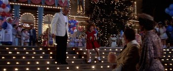 Movie still from “Annie” (1982), directed by John Huston – A man and a girl are walking down the stairs; Wide shot, High angle