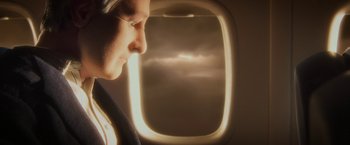 Movie still from “Anomalisa” (2015), directed by Duke Johnson – A man looking out of an airplane window; Close Up shot, Low angle