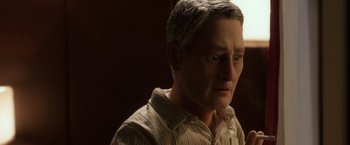 Movie still from “Anomalisa” (2015), directed by Duke Johnson – A man's face in the dark; Close Up shot, Over the shoulder angle