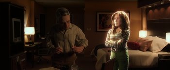 Movie still from “Anomalisa” (2015), directed by Duke Johnson – A man and a woman are standing in a living room; Medium shot, Over the shoulder angle
