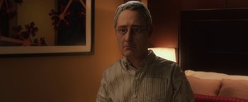 Movie still from “Anomalisa” (2015), directed by Duke Johnson – An older man wearing a head scarf and a striped shirt; Close Up shot, Over the shoulder angle