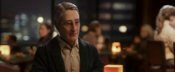Movie still from “Anomalisa” (2015), directed by Duke Johnson – A person wearing a suit and glasses; Close Up shot, Over the shoulder angle