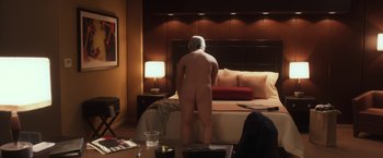Movie still from “Anomalisa” (2015), directed by Duke Johnson – A naked man standing in front of a bed in a room; Wide shot, Over the shoulder angle