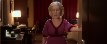Movie still from “Anomalisa” (2015), directed by Duke Johnson – A woman in a purple dress is standing in a room; Close Up shot, High angle