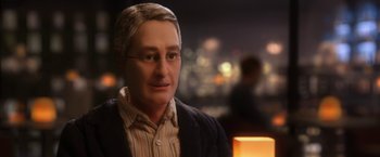 Movie still from “Anomalisa” (2015), directed by Duke Johnson – A man's face in a room with lights; Close Up shot, Over the shoulder angle
