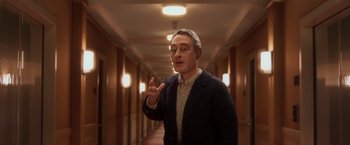 Movie still from “Anomalisa” (2015), directed by Duke Johnson – A man standing in a hallway talking to the camera; Medium shot, Over the shoulder angle