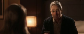 Movie still from “Anomalisa” (2015), directed by Duke Johnson – A man in a suit and tie holding a glass of wine; Close Up shot, Over the shoulder angle