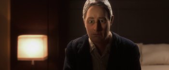 Movie still from “Anomalisa” (2015), directed by Duke Johnson – An older man wearing glasses and wearing a jacket; Close Up shot, Over the shoulder angle
