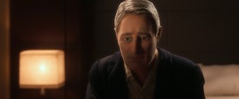 Movie still from “Anomalisa” (2015), directed by Duke Johnson – A person wearing a suit and tie; Close Up shot, Over the shoulder angle
