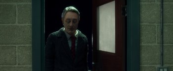 Movie still from “Anomalisa” (2015), directed by Duke Johnson – A man in a suit standing in front of an open door; Medium shot, Over the shoulder angle