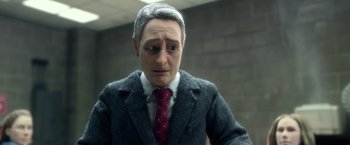 Movie still from “Anomalisa” (2015), directed by Duke Johnson – A man wearing a suit and tie with a red tie; Close Up shot, Over the shoulder angle