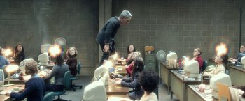 Movie still from “Anomalisa” (2015), directed by Duke Johnson – A man standing in front of a group of people sitting at a table; Wide shot, Over the shoulder angle