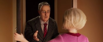 Movie still from “Anomalisa” (2015), directed by Duke Johnson – An older man wearing a suit and tie talking to a young woman; Medium shot, Over the shoulder angle