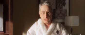 Movie still from “Anomalisa” (2015), directed by Duke Johnson – An older man in a white bathrobe stares at the camera; Close Up shot, High angle