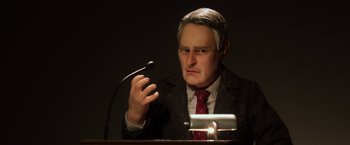 Movie still from “Anomalisa” (2015), directed by Duke Johnson – A man in a suit and tie holding a microphone; Close Up shot, Low angle