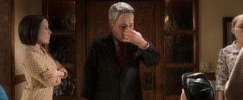 Movie still from “Anomalisa” (2015), directed by Duke Johnson – A man in a suit and tie rubbing his eyes; Close Up shot, Over the shoulder angle