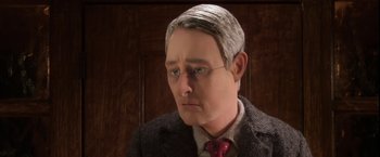 Movie still from “Anomalisa” (2015), directed by Duke Johnson – A wax figure of a man in a suit and red tie; Close Up shot, Over the shoulder angle
