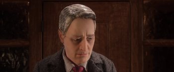 Movie still from “Anomalisa” (2015), directed by Duke Johnson – A person wearing a suit and tie; Close Up shot, Over the shoulder angle