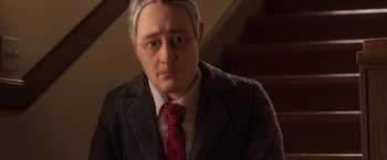 Movie still from “Anomalisa” (2015), directed by Duke Johnson – A person wearing a suit and tie; Close Up shot, High angle