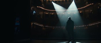 A man standing on a stage in the middle of the night