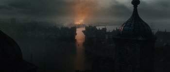 Movie still from “Anonymous” (2011), directed by Roland Emmerich – A view of a city from a distance at night; Extreme Wide shot, High angle