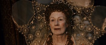 Movie still from “Anonymous” (2011), directed by Roland Emmerich – An older woman wearing pearls and an ornate umbrella; Close Up shot, High angle