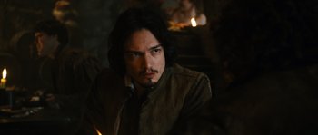 Movie still from “Anonymous” (2011), directed by Roland Emmerich – A person with long black hair; Close Up shot, Over the shoulder angle