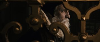 Movie still from “Anonymous” (2011), directed by Roland Emmerich – An old man with a beard and long white beard; Close Up shot, Over the shoulder angle