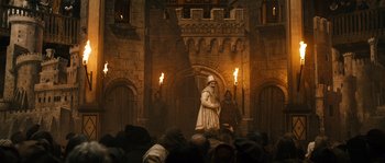Movie still from “Anonymous” (2011), directed by Roland Emmerich – A statue of a man holding a sword in front of a crowd of onlookers; Wide shot, Low angle