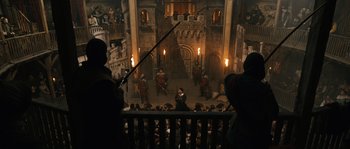 Movie still from “Anonymous” (2011), directed by Roland Emmerich – A scene of a medieval theatre with people in the background; Extreme Wide shot, High angle