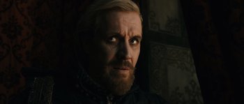 Movie still from “Anonymous” (2011), directed by Roland Emmerich – A person with a goatee; Close Up shot, Over the shoulder angle